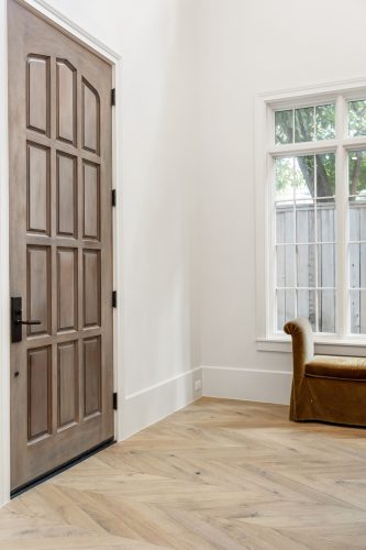 Grand entryway and door in English Tudor style home.