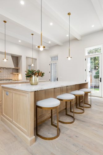 Neutral cozy kitchen with european white oak flooring in English Tudor home.