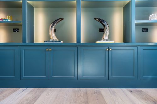 Teal blue built-in shelving that's paired with light toned European White Oak flooring.