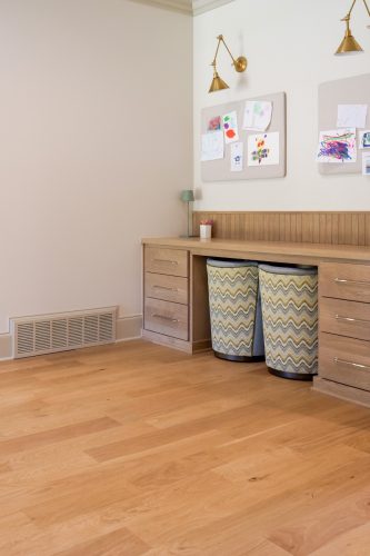 Study nook featuring wood floors, storage drawers, and warm design.