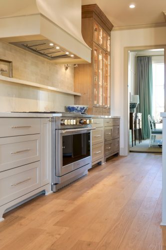 Interior kitchen scene with wood floors, island seating, and natural materials throughout