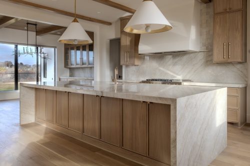 Warm modern interior design showcasing kitchen with natural materials and integrated wood flooring