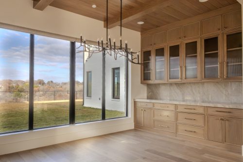 Dining space with wood-paneled ceiling, built-in cabinetry, and wide-plank hardwood floors