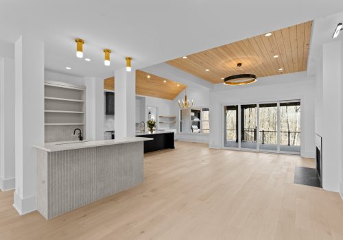 Open kitchen and living area with Silvian Laakso-Valley wood flooring connecting entertaining spaces in the Axios Charlotte Home of the Year.