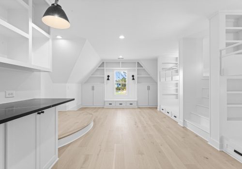 Custom bedroom with built-in bunkbeds and white oak flooring.
