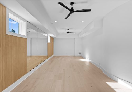 Bright studio space with a large ballet studio mirror and european white oak flooring.