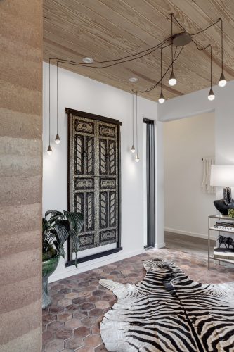 Entryway with natural wood flooring and warm earth tones creating a welcoming, nature-inspired first impression