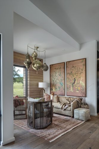 Side lounge with warm wood flooring, layered textures, and soft natural light creating a cozy, grounded retreat