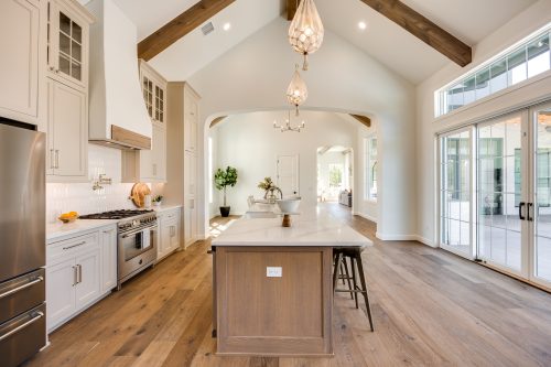 Oklahoma City home kitchen with exposed beams and warm-toned hardwood floors.