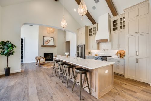 Open-concept kitchen and dining area with cohesive hardwood flooring and neutral tones.