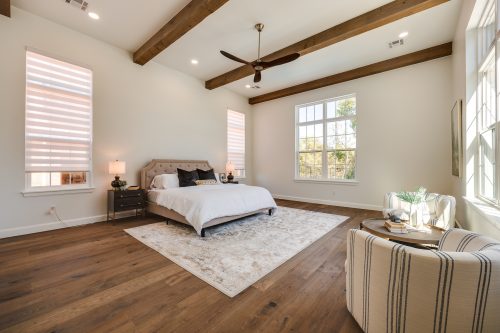 Bedroom Interior design with exposed beams and rustic-modern wood flooring.
