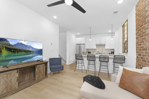 Living space with exposed brick wall and open layout in Charlotte condo
