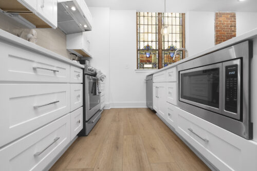 Kitchen with clean-lined cabinetry and waterproof flooring