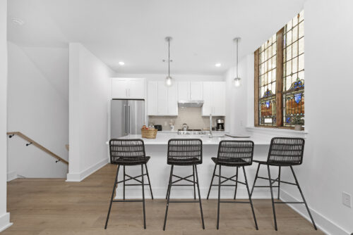 Open kitchen and living space with large island and wood-look SPC flooring in Wesley Heights