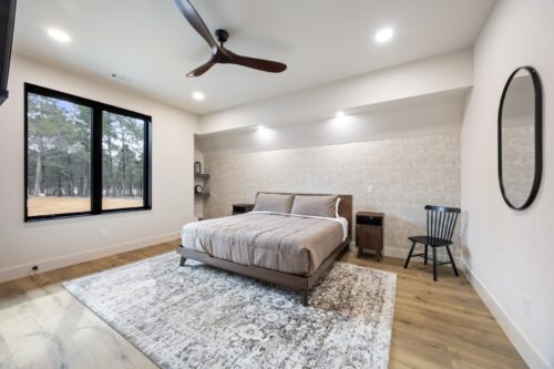 Spacious cabin bedroom with layered textures and grounding wood-look Retrospect floors