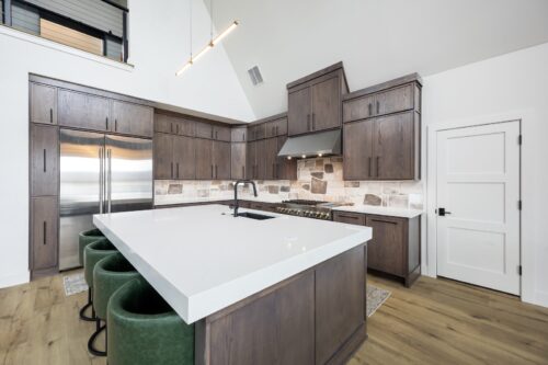 A-frame kitchen interior with modern cabinetry and organic wood-look floors