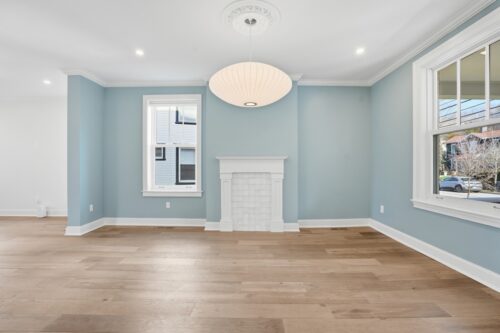 Soft blue interior with fireplace and natural oak flooring