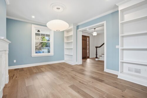 Bright living space with modern pendant and warm wood floors