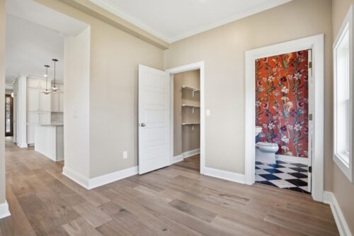 Open concept layout unified by warm toned flooring