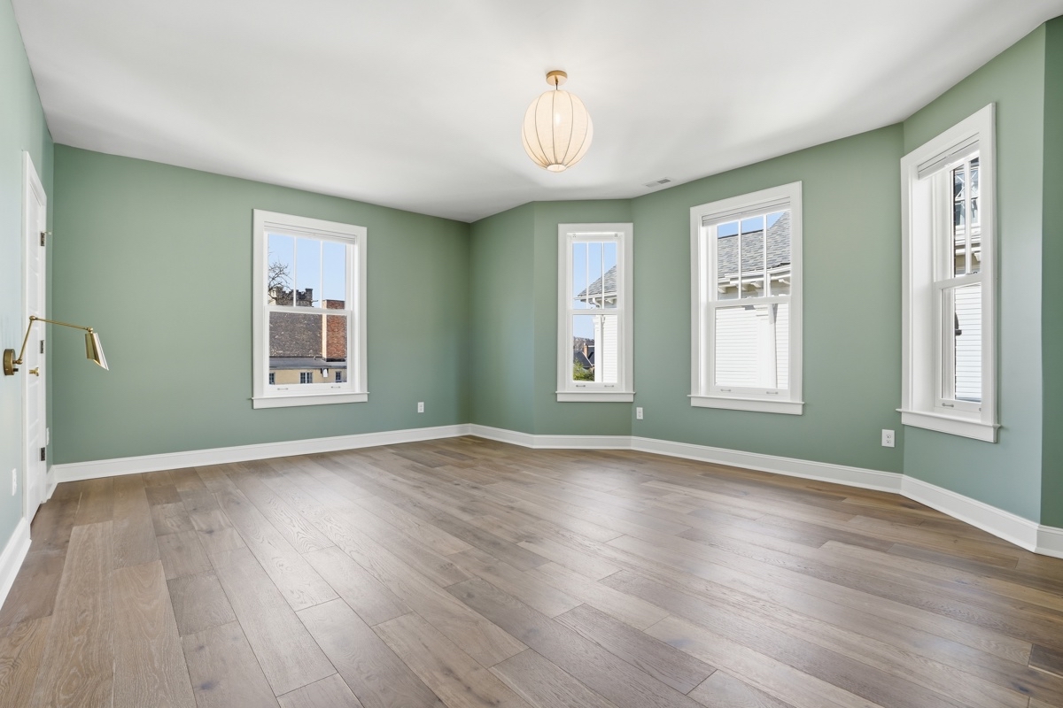 Soft safe green interior paired with warm wood flooring