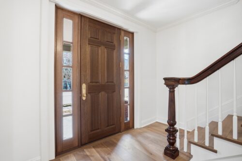Entry staircase with Floormade custom treads and original stained glass feature