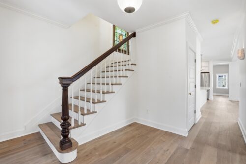 Classic stair design paired with wide plank wood flooring and Floormade treads