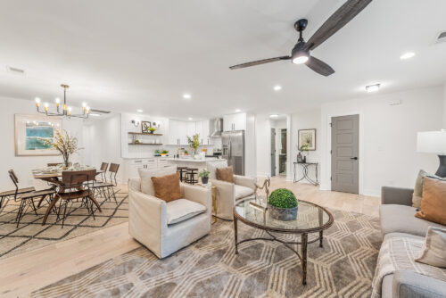 Open living space with hardwood flooring and neutral interior design