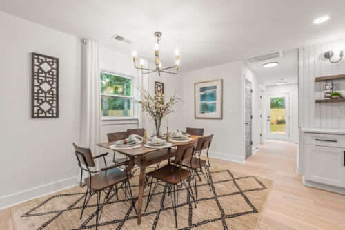 Dining area with wood floors and modern lighting fixture