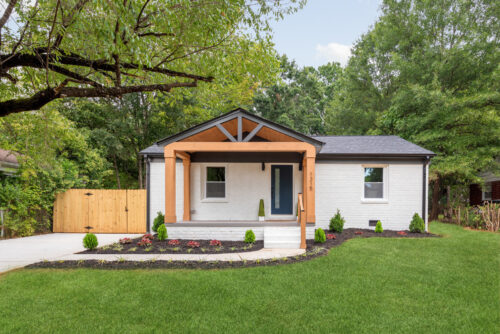 Updated home exterior in Charlotte NC with covered porch and natural wood accents