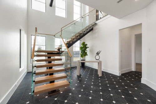 Front entry with black and white tile and custom wood stair design Sugar Land TX