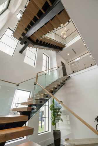 Sugar Land TX 3 level staircase with handcrafted Floormade treads with integrated lighting