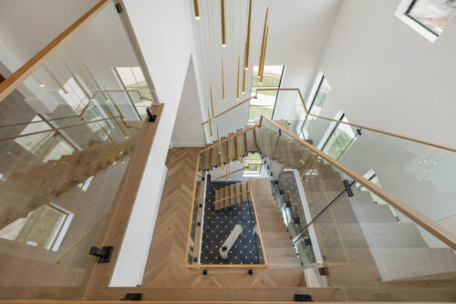 Modern staircase with Killarney Parkfield flooring and seamless wood stair design