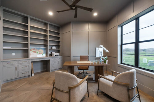 Home office with paneled wood flooring and built-ins in Sugar Land TX