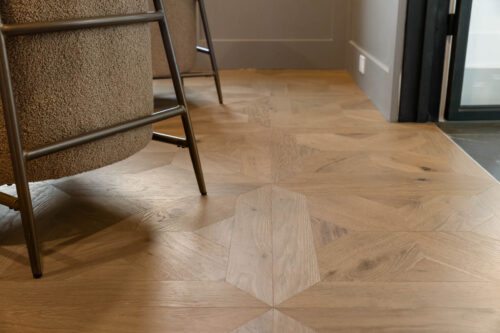 Coastal home office with pattern hardwood flooring panels and soft textures