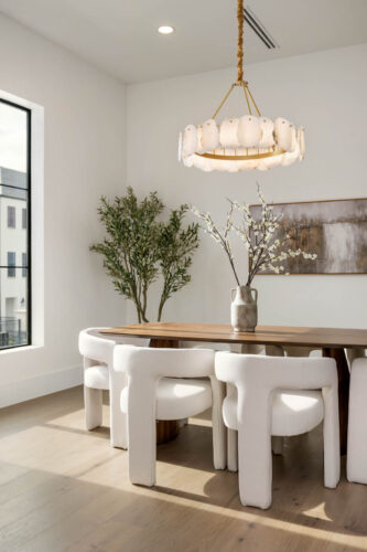 Dining area with wide plank oak flooring and modern lighting Sugar Land TX