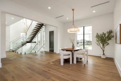Open dining space with wood flooring and natural light in Houston-area home