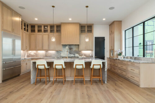 Bright kitchen with Killarney Parkfield flooring, coordinating wood cabinets and natural light