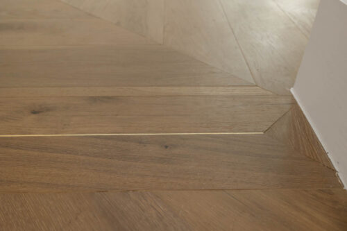 Wood panel details on patterned flooring
