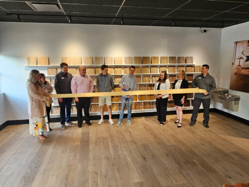 Ribbon cutting celebration at the new Real Wood Floors Pittsburgh location featuring wood flooring showroom displays