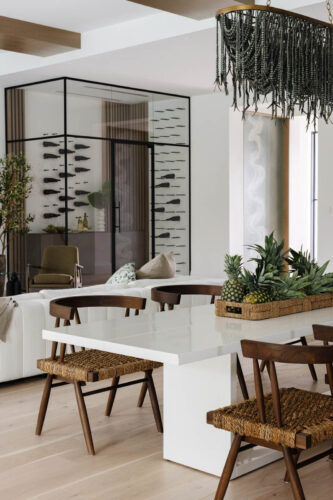 Coastal dining room with Silvian Taivas hardwood floors and clean design