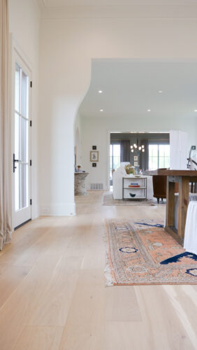 Dining space featuring detailed trim work and matte finish real wood floors