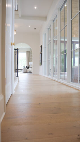 Light-filled transitional space with airy architecture and real wood flooring