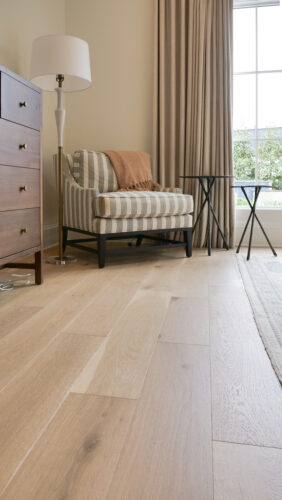 Elegant sitting nook with tailored furnishings and soft tan oak flooring