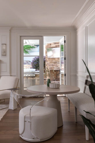 Inviting breakfast space designed with warm white oak flooring and seamless indoor-outdoor connection.