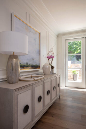 Light-filled nook with matte hardwood flooring and muted cabinetry.