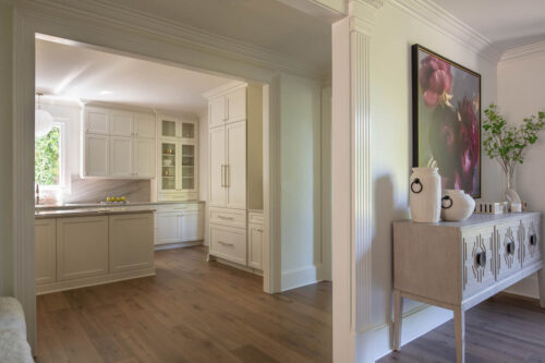 Open kitchen with matte finish hardwood flooring and seamless flow into adjoining living spaces.