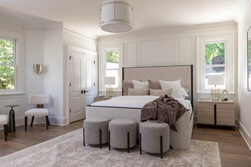 Luxury bedroom featuring warm white oak flooring and classic transitional design.