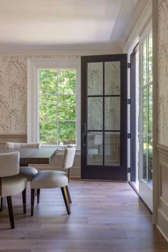 Hand-painted wallpaper complements warm European white oak flooring in this remodeled home.