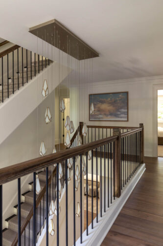 Upstairs landing featuring Silvian Virta European white oak flooring and statement chandelier.