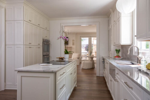 Luxury Raleigh kitchen designed with wide plank engineered hardwood flooring and natural light.